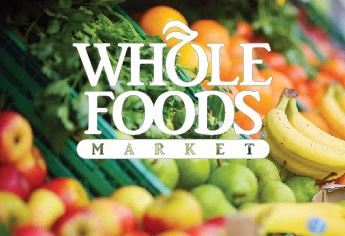 a display of fruits and vegetables with the whole foods market logo